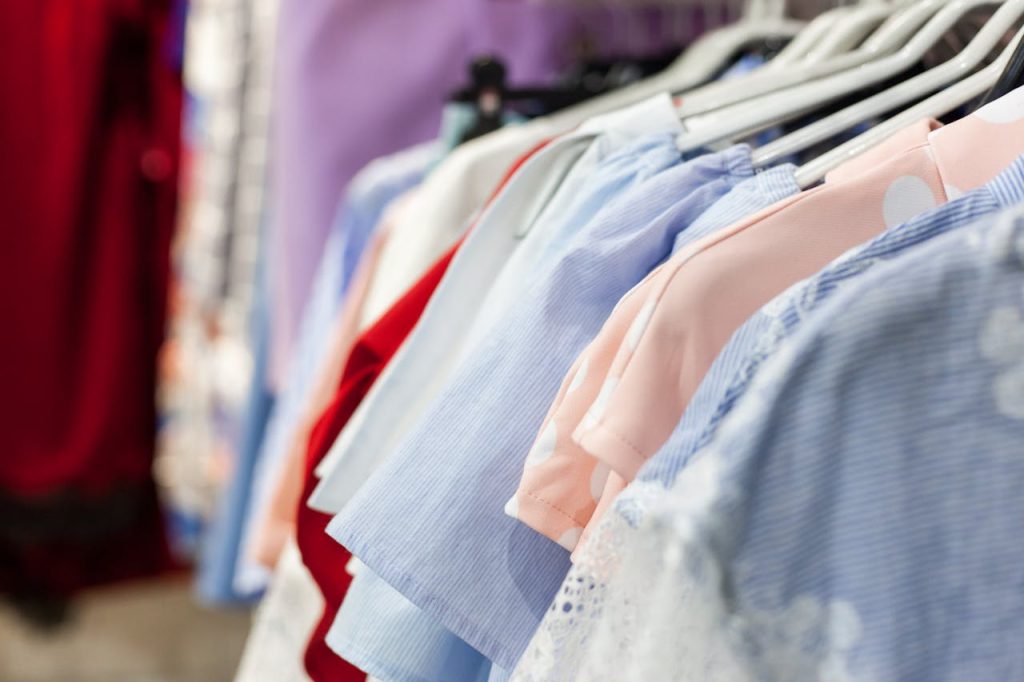 pexels-photo-7138971 A collection of colorful women's blouses neatly hung on a clothes rack inside a boutique.